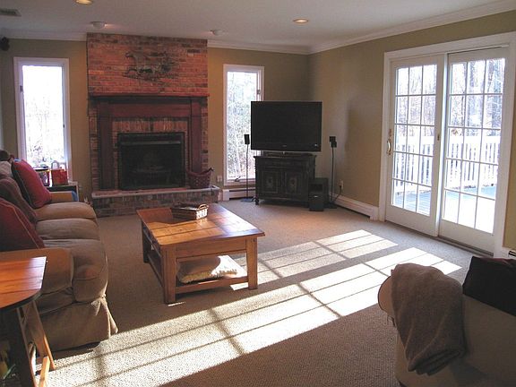 Spacious Family Room with wood-burning fireplace leads to huge deck...