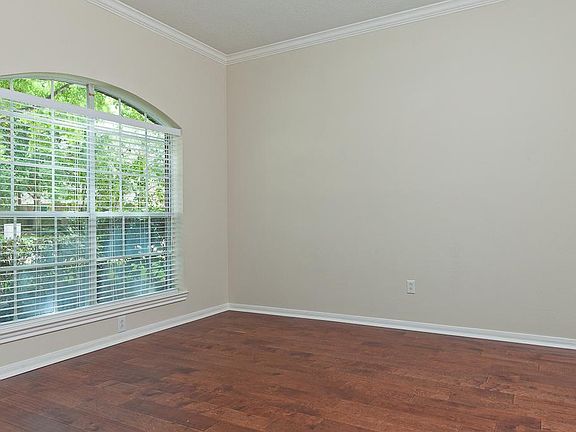Study or formal living room with engineered hardwood floor to the left of the entry hall