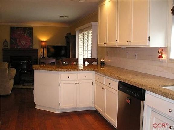 The kitchen opens up into the family room.  The sliding glass doors you see on the right open to the big back yard.