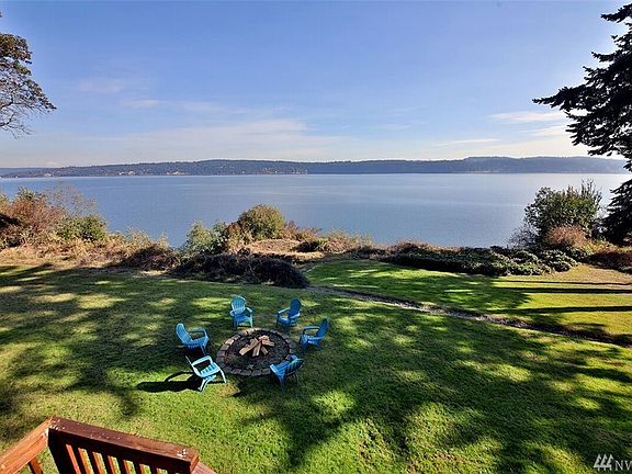 The front of the home is beautifully landscaped with a circular drive.