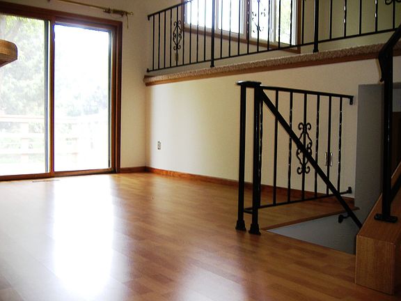 Dining room with new floor. Sliding door leads to wood deck.