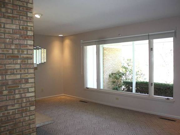 Opposite view showing the picture window and large covered front porch beyond.