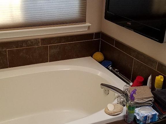 Master bathroom soaking tub with TV