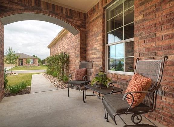 The brick exterior of this Surrey Crest gives the front porch a cozy feel.