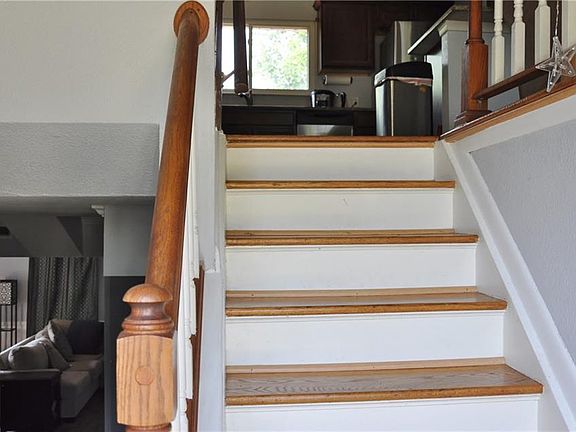 Entry stairs and foyer that lead to the main living space upstairs and the large living space and separate master bedroom downstairs