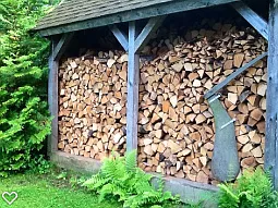 Woodshed stacked with 3 cords of Kiln Dried Wood.