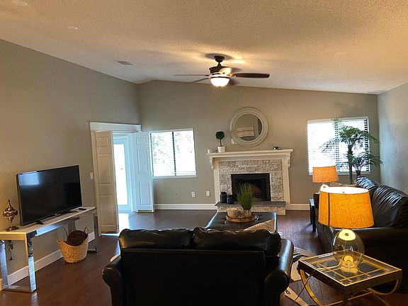 Living room with wood burning fireplace. Smart tv.