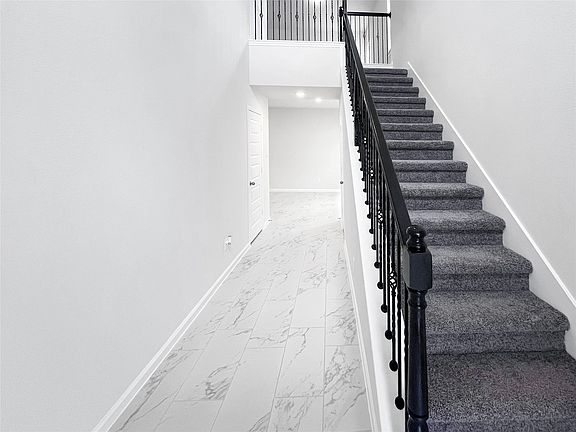 The Sparrow II- Foyer and Wrought Iron Staircase.