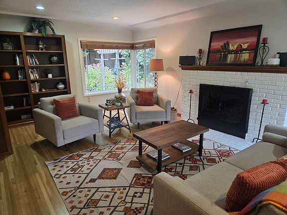 Large windows frame the lush greenery, inviting nature indoors and creating a tranquil backdrop for meditation or a quiet afternoon with a book. Sink into one of two plush armchairs or curl up on the soft sofa.