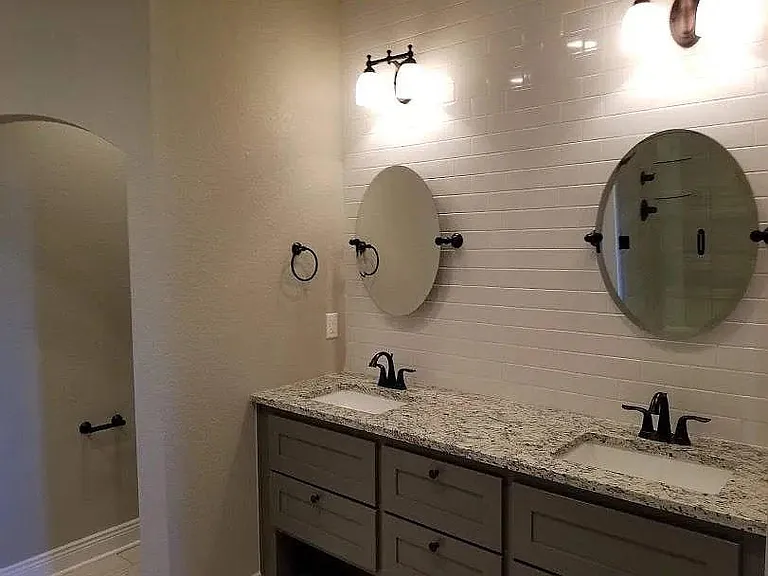 main bath with two sinks and mirrors