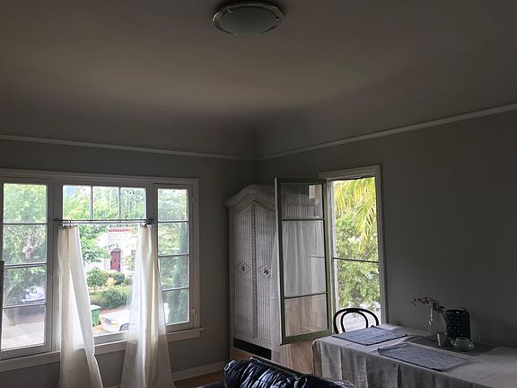 Corner windows in the living room. Clear open view of Hollywood Hills.