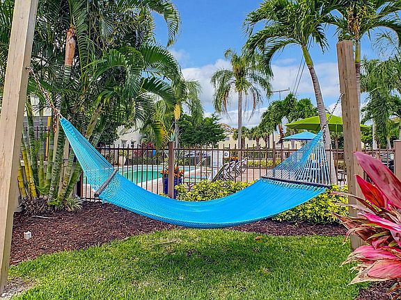 Drift away in a blissful slumber, nestled in the poolside hammock garden under swaying palms.