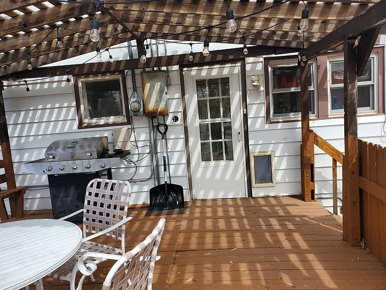 Large deck with exterior lighting. Entry for unit is off the back of the home.