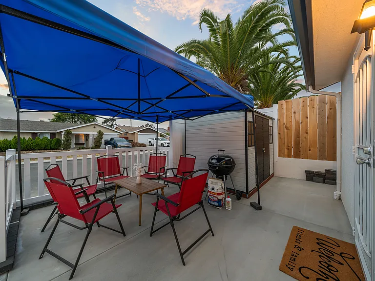 Enjoy a shaded outdoor seating area perfect for relaxing or dining al fresco.