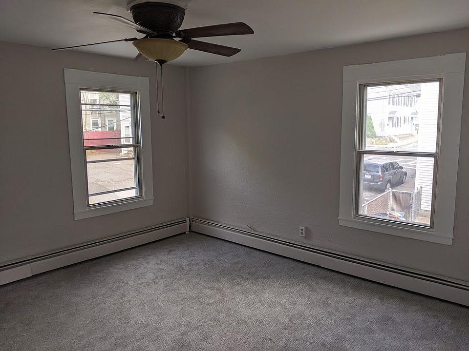 Large living room with large windows with lots of natural lighting