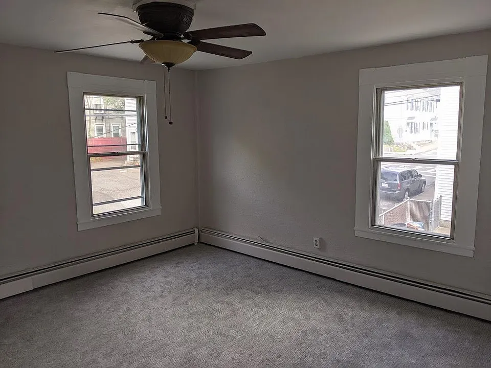 Large living room with large windows with lots of natural lighting