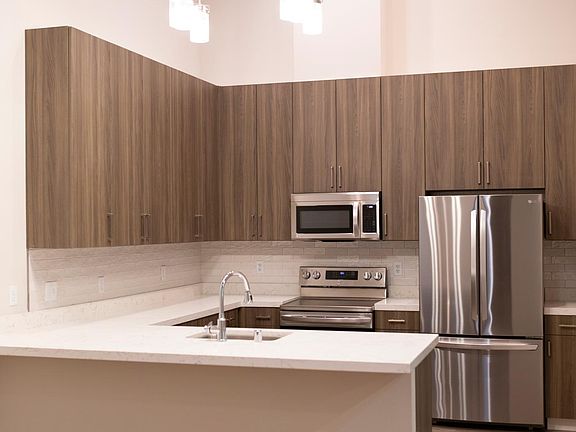 Unit 201: Kitchen with high ceilings, skylights, high-end appliances, lots of cupboard space, dining area, and a counter bar top that would accommodate 3 stools.