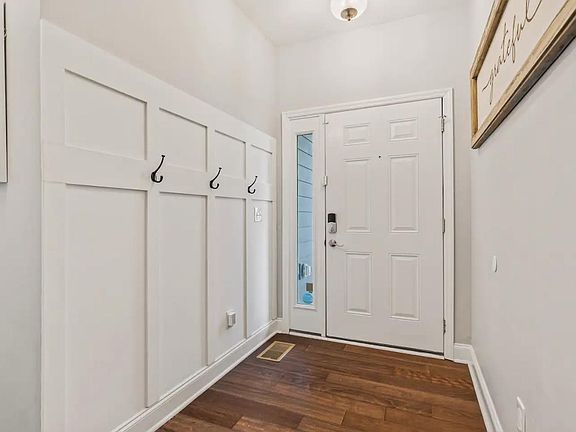 Entry Hallway with half bathroom for guest use. Hooks for jackets and the second entry door to the garage.