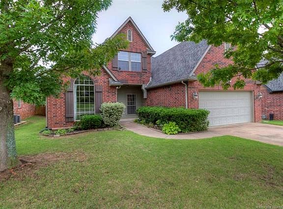 Full brick home in Broken Arrow schools with 3 car tandem garage.