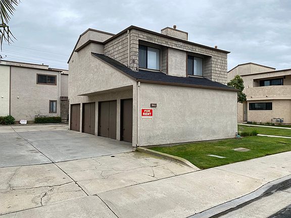 Left side street-view of the 4-unit property; each unit has its own single-car garage.