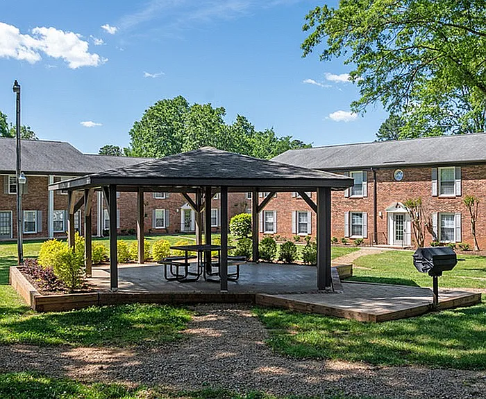 Relax and unwind in this serene courtyard, featuring a charming gazebo and vibrant landscaping.