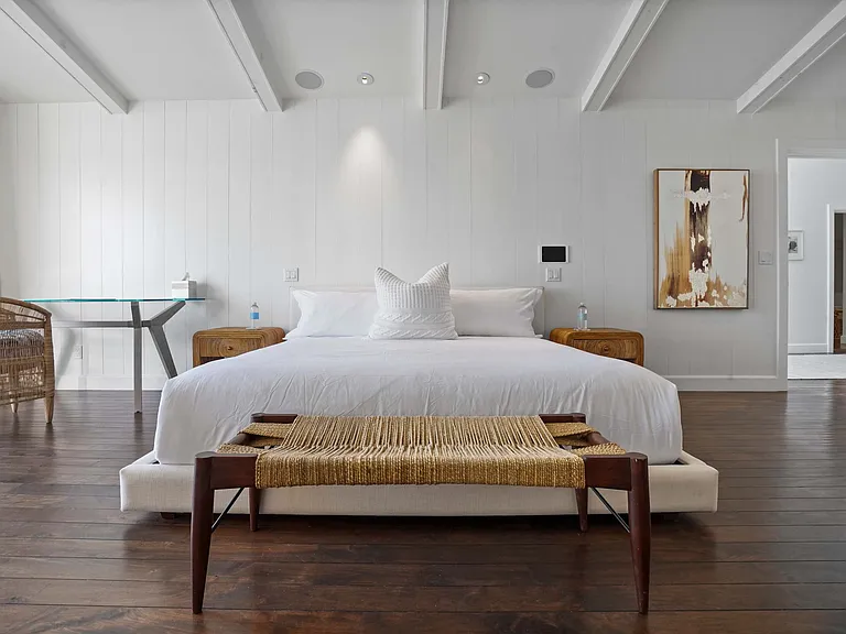 Drift into comfort on a bed framed by artisanal craftsmanship.