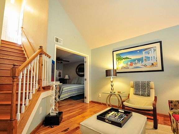 Looking into lower level master bedroom, thru open French doors, from sitting area