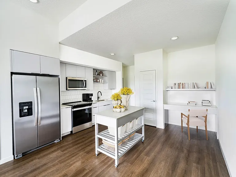 A light-cabinet kitchen with a movable island offers flexible, effortless living throughout your Modera Encore Tampa home.