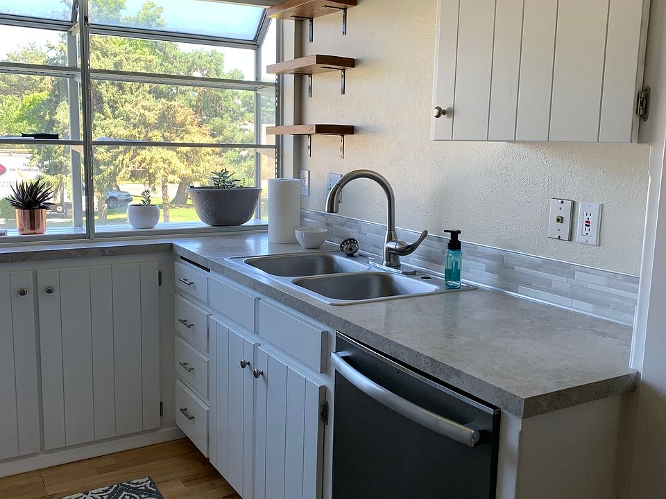 Kitchen (fridge, microwave, and stove on opposite wall)
