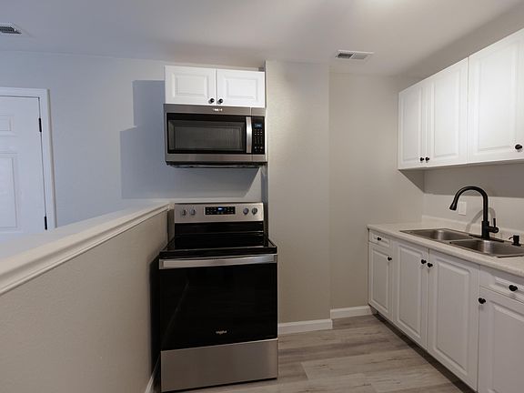 Kitchen with New Stainless Steel Refrigerator, Range, and Microwave