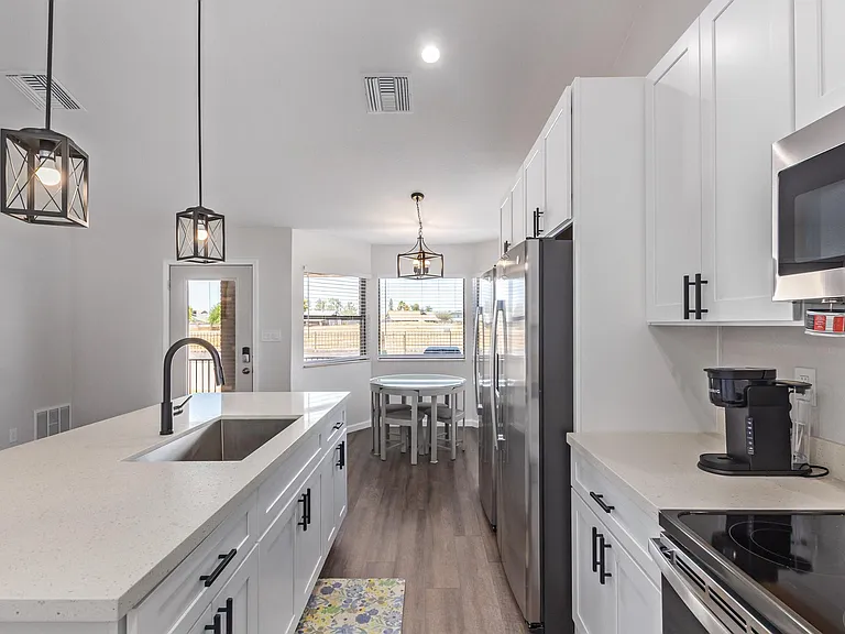 Kitchen equipped with Keurig, toaster oven, and some basics (silverware, cups, cutting boards).