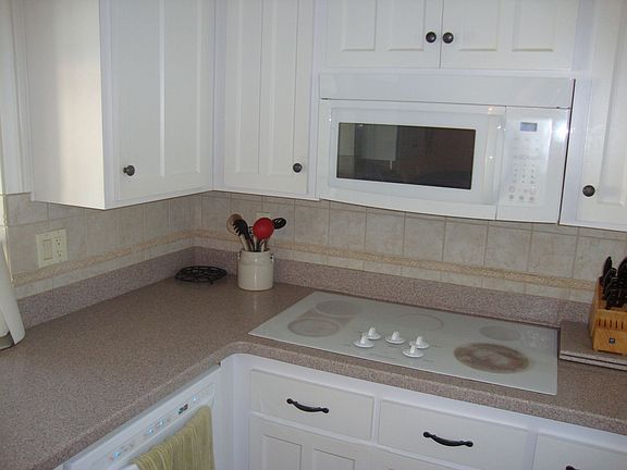 Modern kitchen with built in microwave and countertop and ovens