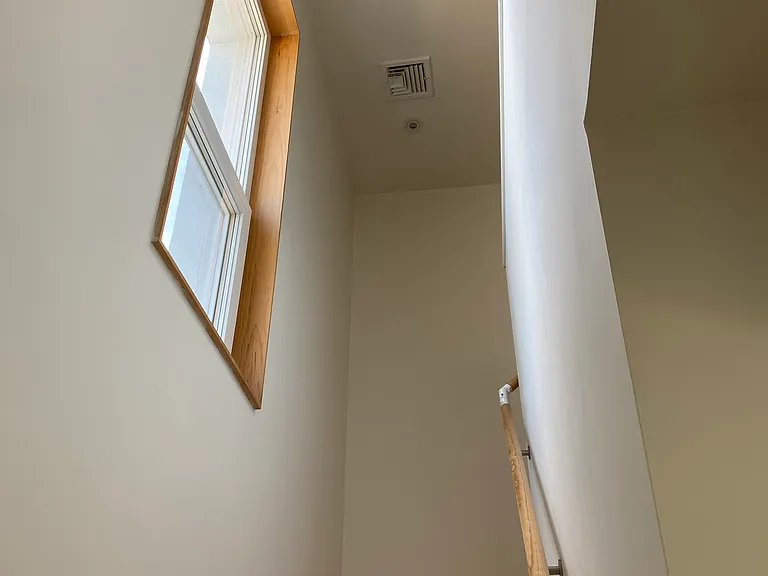 Stair to second floor. High ceilings. Large window. Natural light.