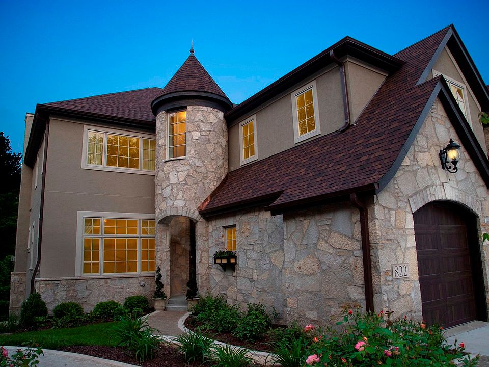 All authentic stone & stucco, signature turret, 2 car garage w/ concrete drive