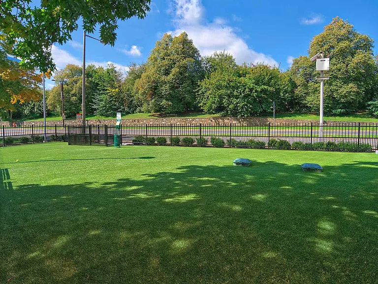 Large AstroTurf dog park off the West Tower is one of three dog parks located throughout the community