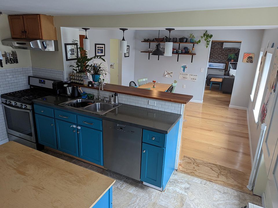 Open kitchen with island, bar, and pantry closet