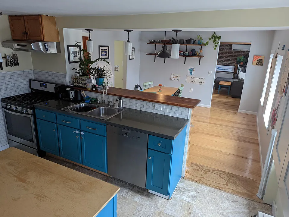 Open kitchen with island, bar, and pantry closet