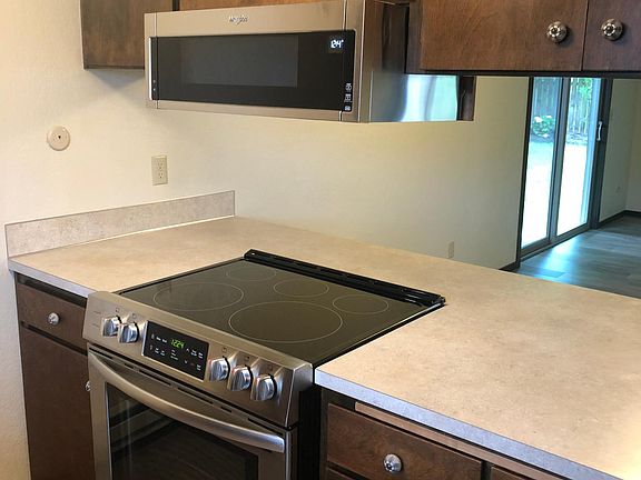 Kitchen with new range and microwave hood. Faces dining nook area.