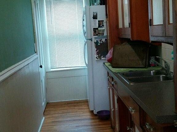 Galley kitchen, door on left goes to basement storage/laundr