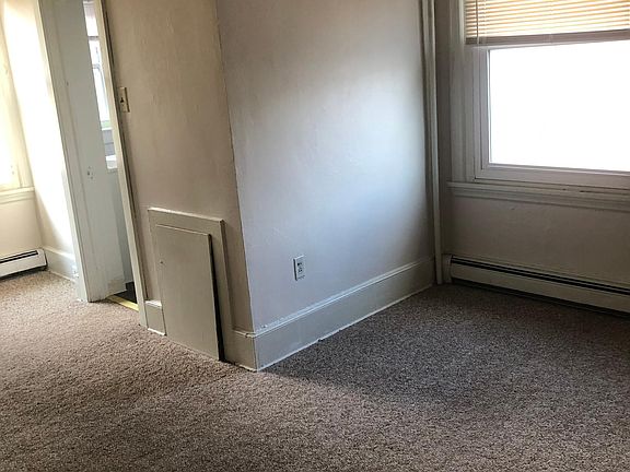 Bedroom with two windows, two large closets, and bathroom.