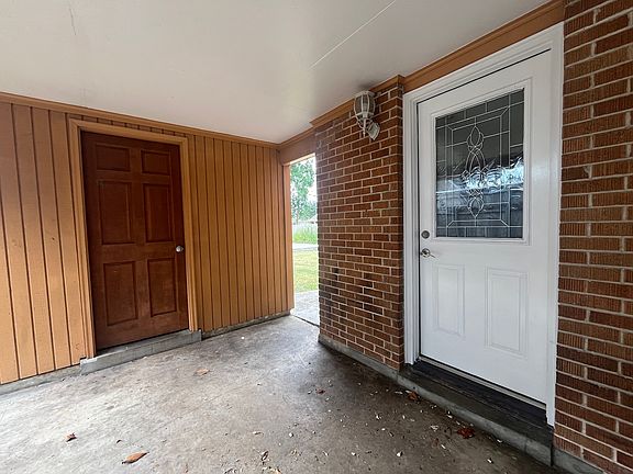 Side Door of Home to Kitchen & Door to Laundry Room w/ Washer&Dryer and Covered Carport