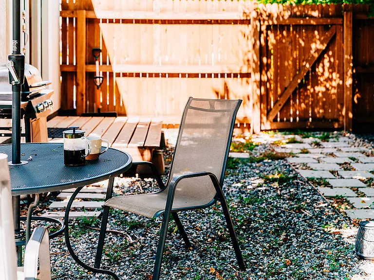Fully fenced-in backyard. Patio area with umbrella under the Catalpa trees.