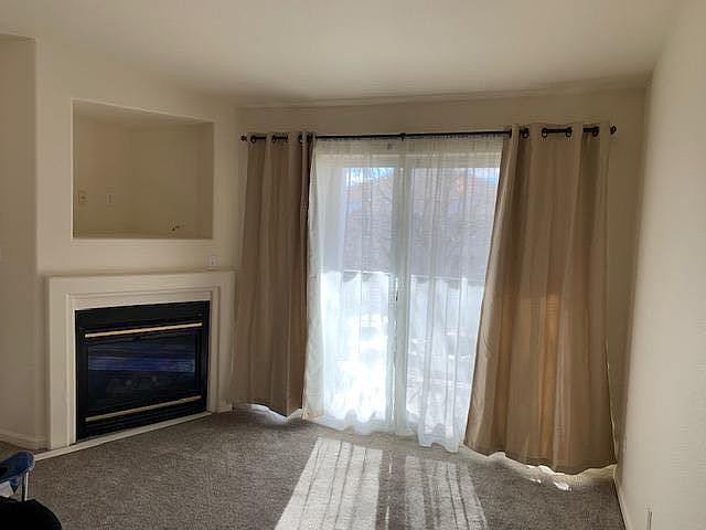 cozy family room with sun drenched balcony and gas fireplace