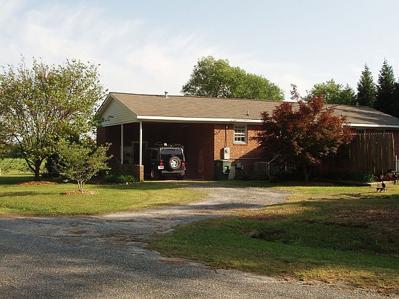 Under-roof carport; deck with built-in hot tub and privacy fence