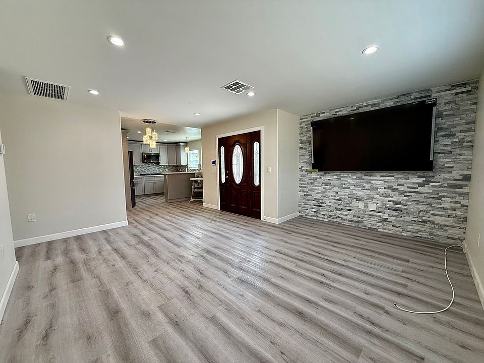 View of living room, front door, into kitchen.