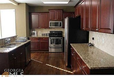 Absolutely beautiful kitchen with stainless steel appliances and gorgeous hardwood floors