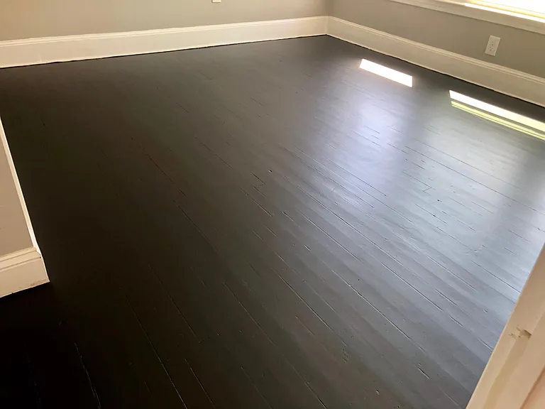 front bedroom / office with dark wood floors.