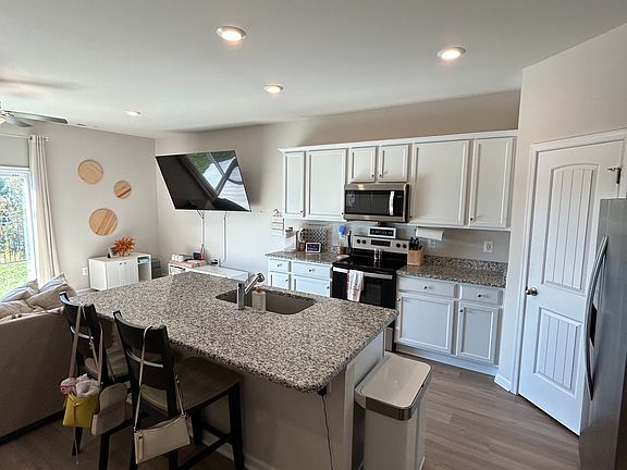 Kitchen with large pantry and stainless steel appliances