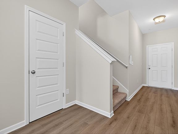 Foyer entrance featuring stairs and wood finished floors