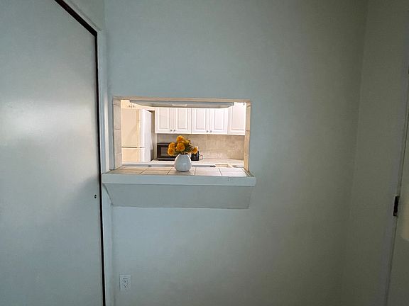 Drive-thru connecting kitchen to entry and living room area.
